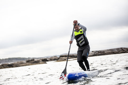 Baltic SUP Elite Buoyancy Aid UV Yellow On Male Paddleboarder Front