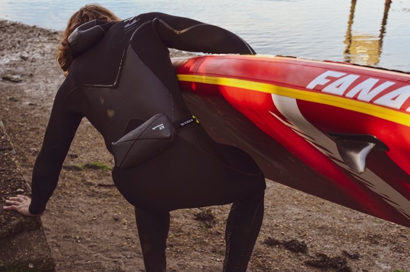 Black Spinlock Alto Inflatable Belt Pack being worn by Paddleboarder