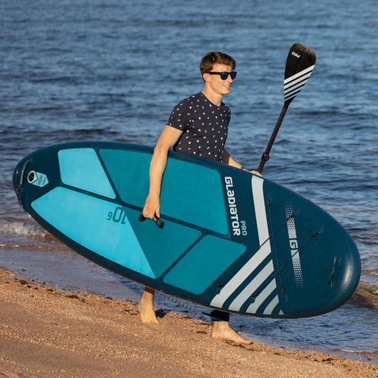 Gladiator Pro 10'6 Paddleboard Being Carried On The Beach