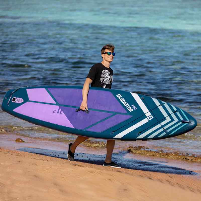 Gladiator Pro 11'2 Paddleboard Being Carried On The Beach