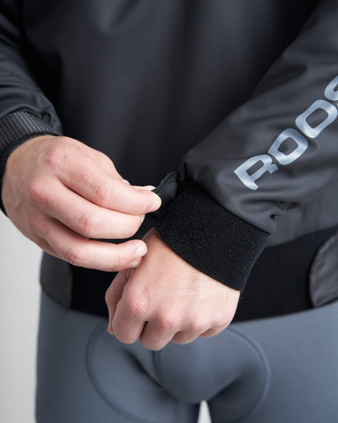 Wrist Details of Rooster Pro Aquafleece Top in Black, worn by a male model