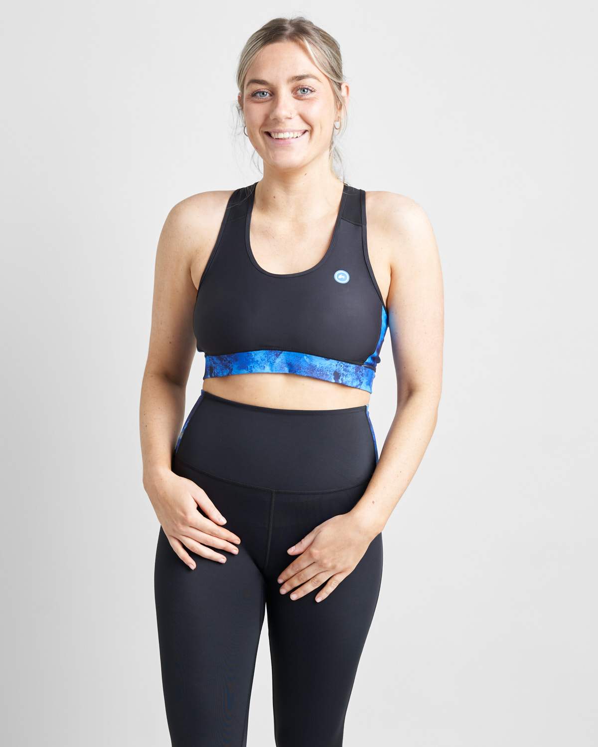 Rooster Sports Bra/Bikini Top in black with a blue pattern, worn by a female model